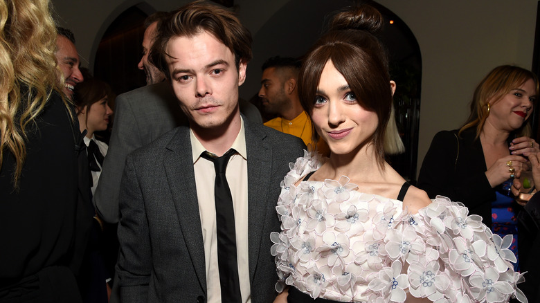 Natalia Dyer and Charlie Heaton posing for photos