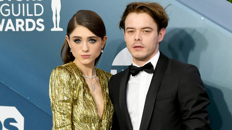 Natalia Dyer and Charlie Heaton posing for photos