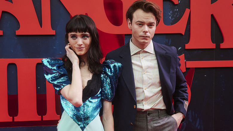 Natalia Dyer and Charlie Heaton posing for photos