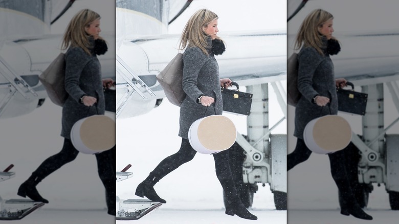 Natasha Archer disembarking a plane in the snow