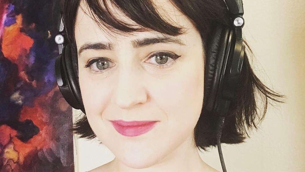 Mara Wilson smiling, wearing headphones