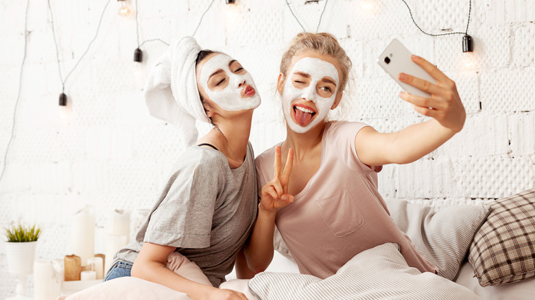 Woman with face masks on taking a photo