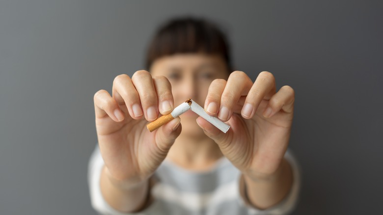 Woman breaking a cigarette