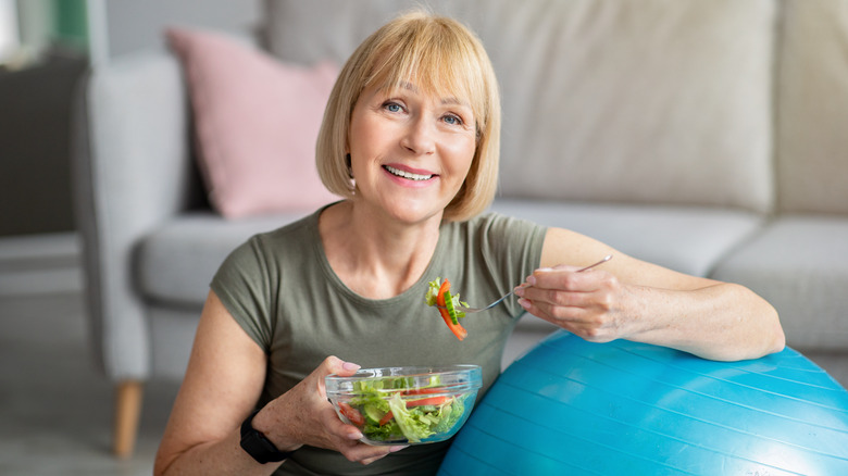 Older woman eating salad