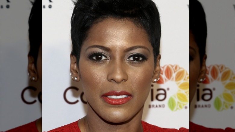 Tamron Hall in red looking at camera