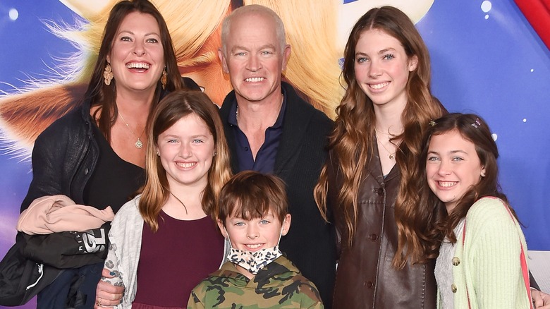 Neal McDonough posing with his wife and kids 