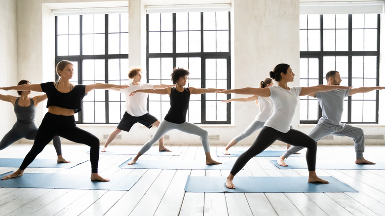 People stretch in a yoga class