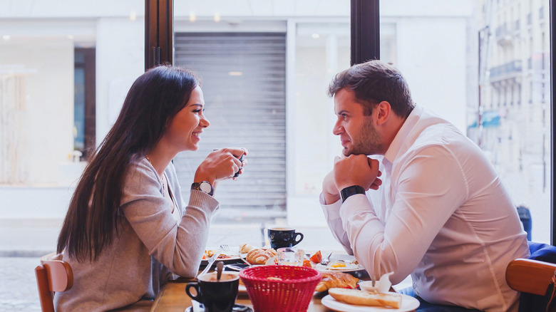 couple smiles at a restaurant