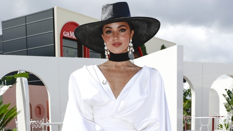 Woman wearing choker scarf and V-neck dress