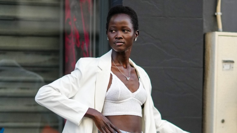 Woman wearing dainty necklace with V-neck top