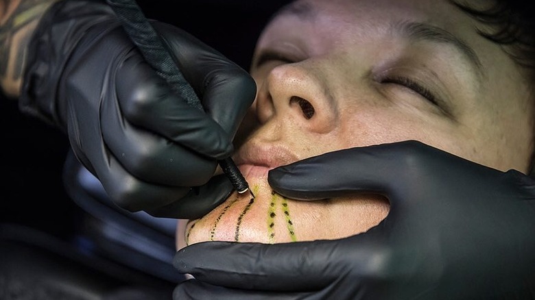 Woman with face tattoo