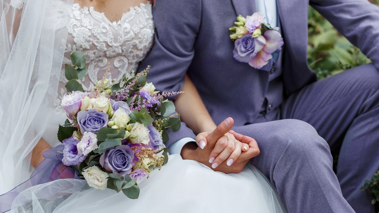 Bride and groom with purple bouquet