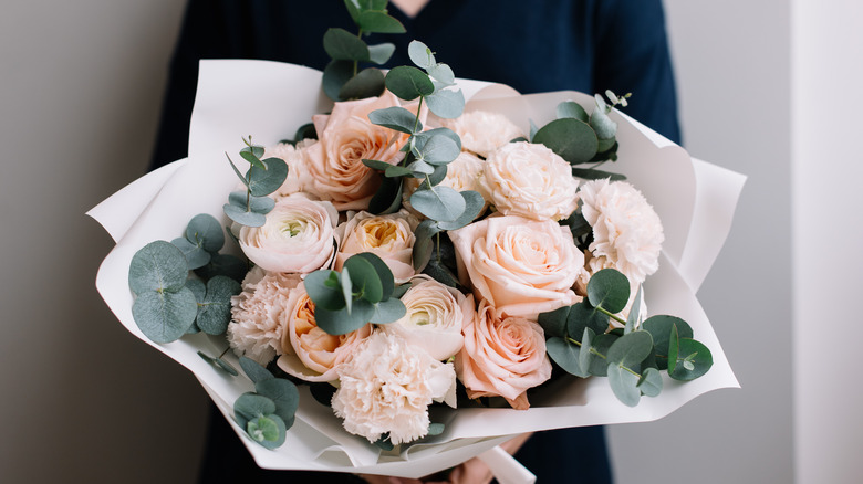 Person holding a full bouquet