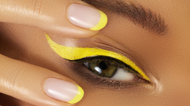 Woman wearing neon yellow eyeliner