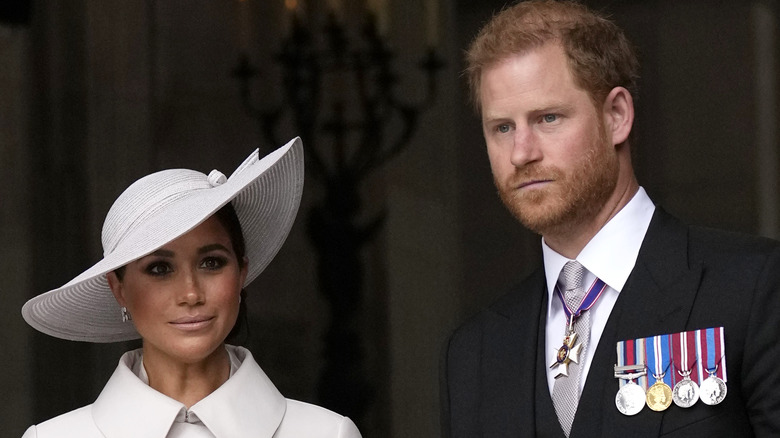 Prince Harry and Meghan Markle looking serious