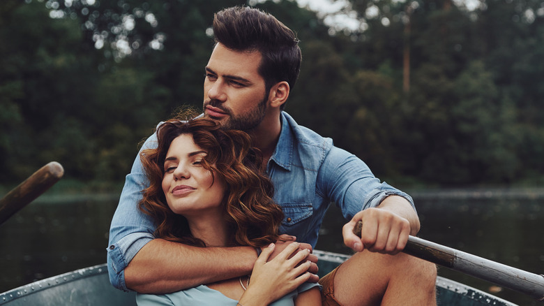 couple cuddling in canoe