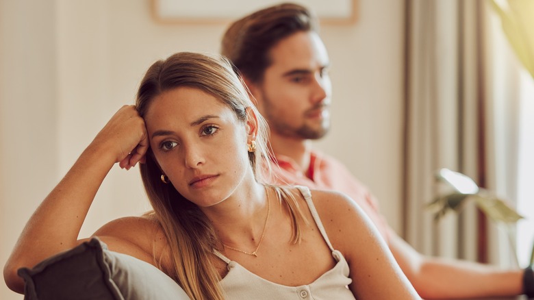 Woman thinking with man behind