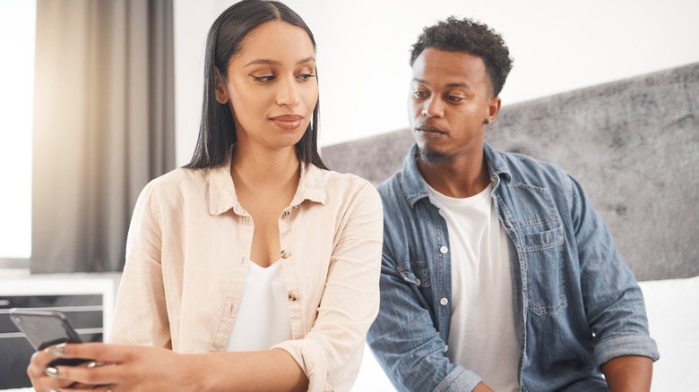 Man looking at woman's phone