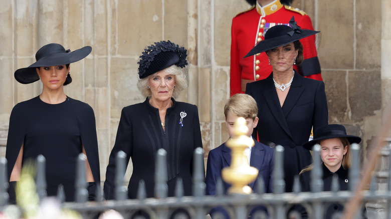 Kate Middleton, Queen Camilla, & Meghan Markle standing together