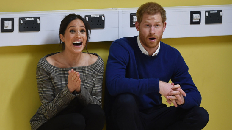 Meghan Markle and Prince Harry reacting excitedly