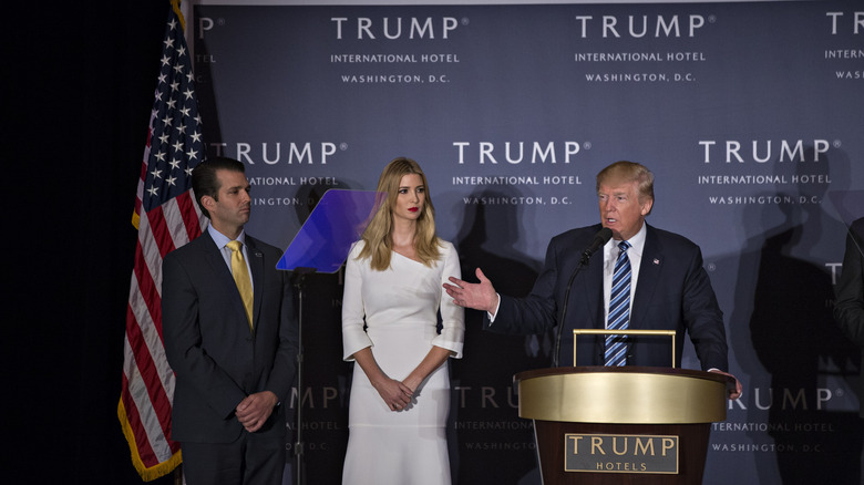 Ivanka, Don Jr, and Donald Trump posing 