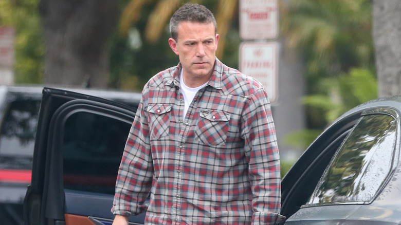 Ben Affleck scowling near a car 