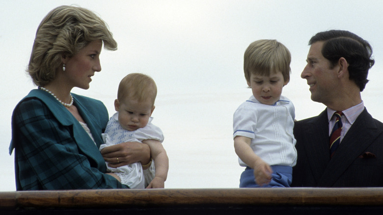 Princes Diana holding Prince Harry whole Prince Charles holds Prince William