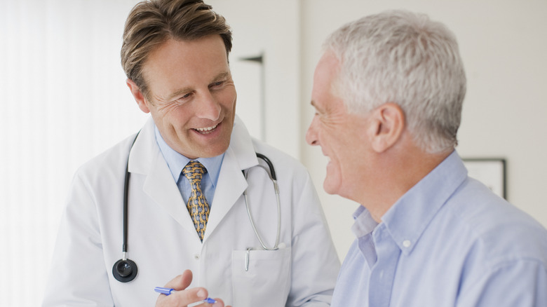 Male doctor speaking with male patient