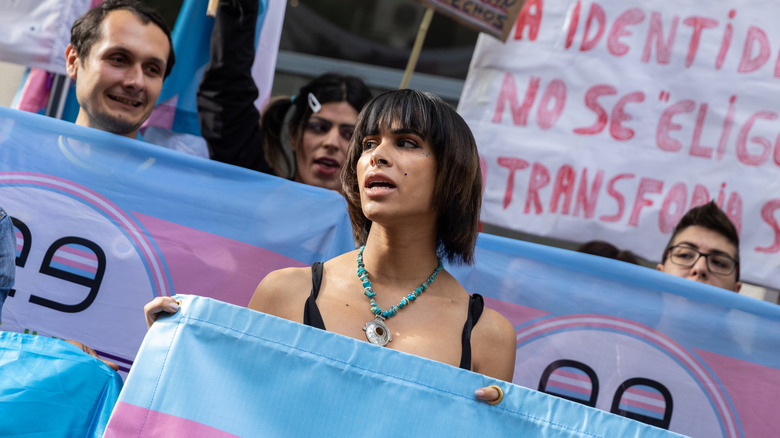 pro-trans rights protestors holding signs in Spain