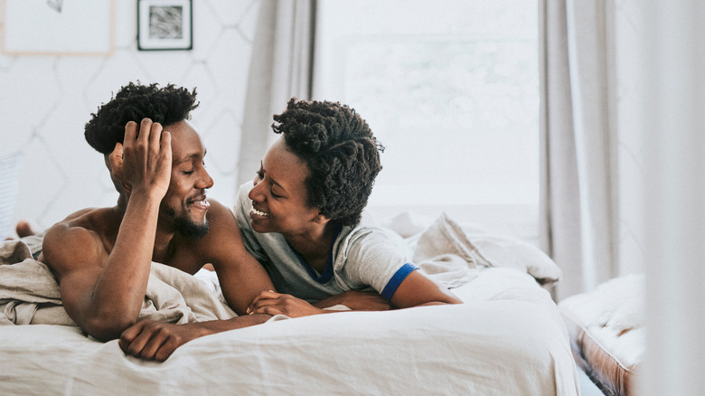 Couple smiling in bed 