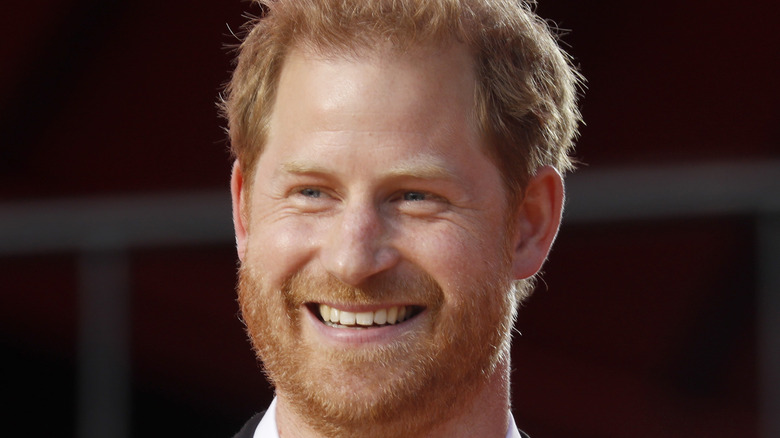 Prince Harry smiling on stage 