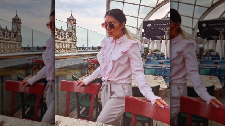 Woman in pink ruffle blouse