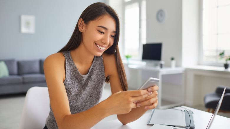 woman scrolling on phone