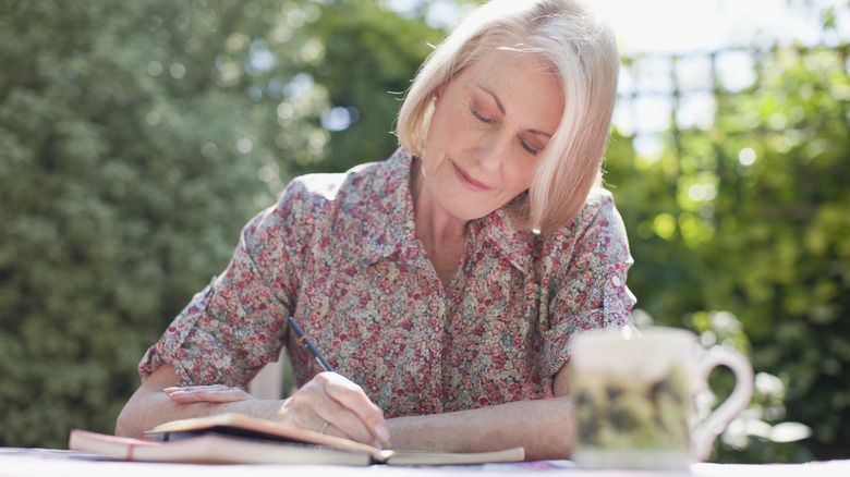 woman journaling outside