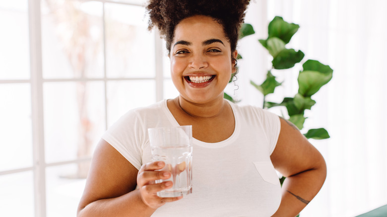 woman holding glass of water