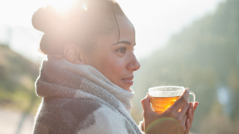 woman holding tea outside