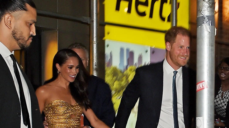 Meghan Markle and Prince Harry walking and smiling