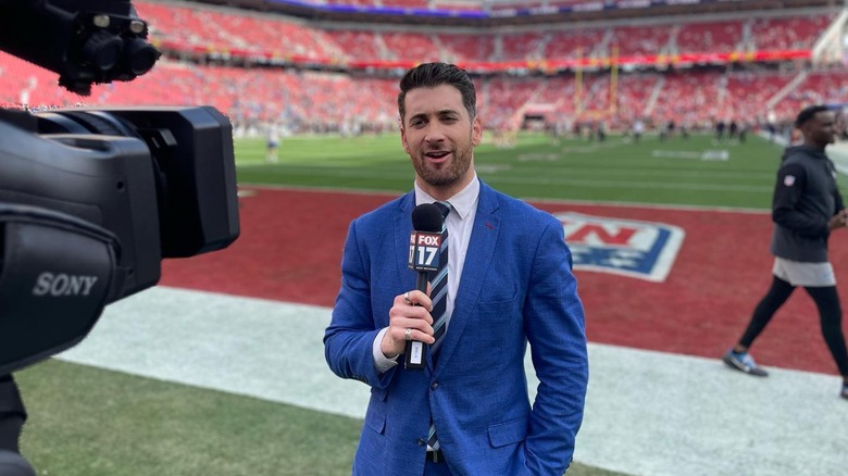 Max Goldwasser during a news report on a football field