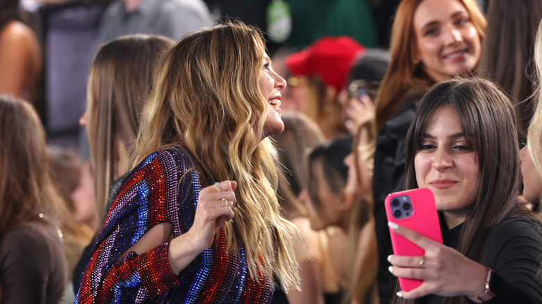 Ellen Pompeo smiling with crowd of  fans 