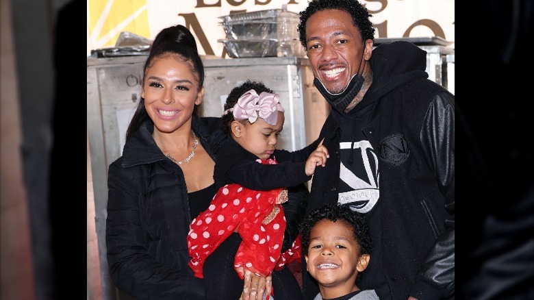 Nick Cannon with two of his children and their mother.