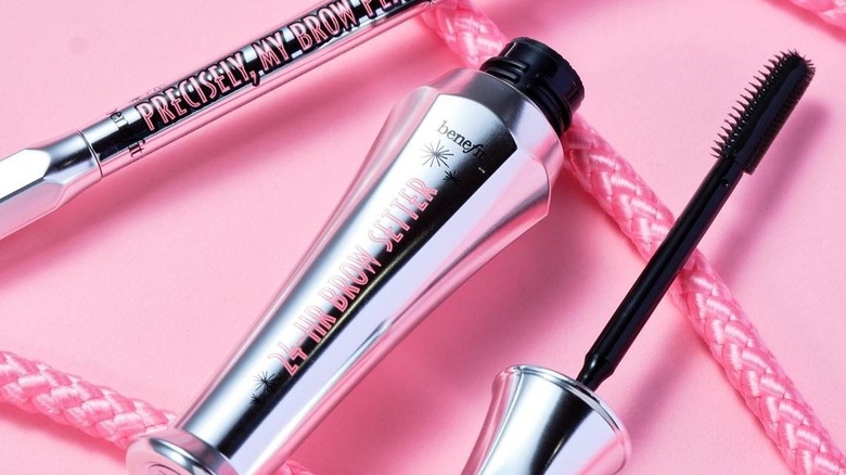 A tube of the Benefits clear gel next to a Benefit eyebrow pencil 