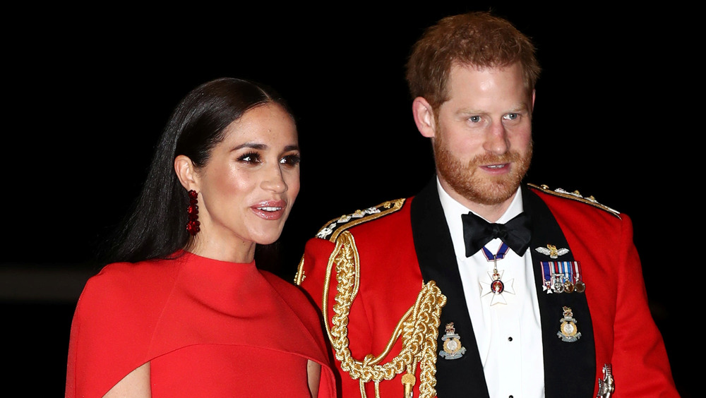 Prince Harry and Meghan Markle wearing red