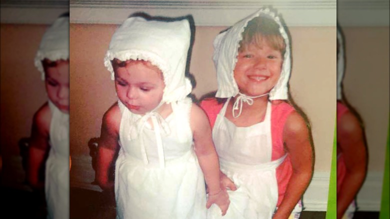 Noelia Voigt and her sister in white bonnets