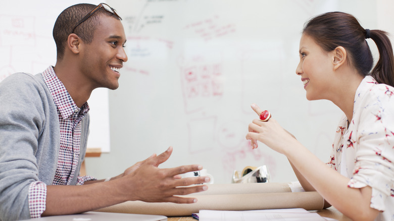 Man leaning toward woman talking