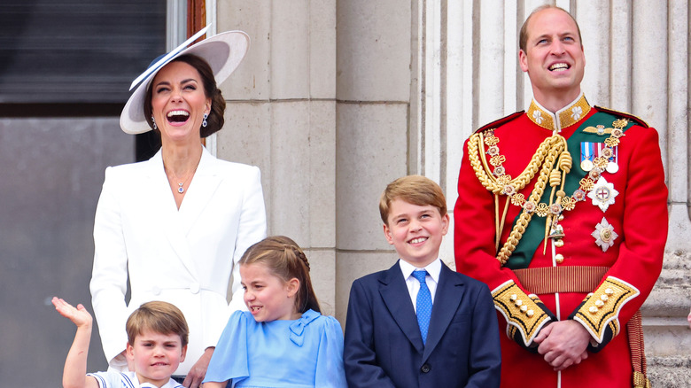 The Wales family laughing on balcony