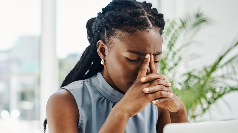 stressed woman sitting at computer