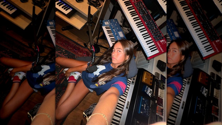 Lola Consuelos taking a selfie surrounded by keyboards