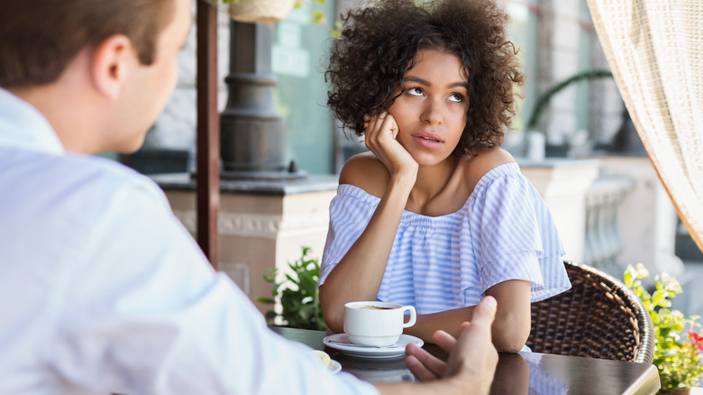 woman rolling eyes at man