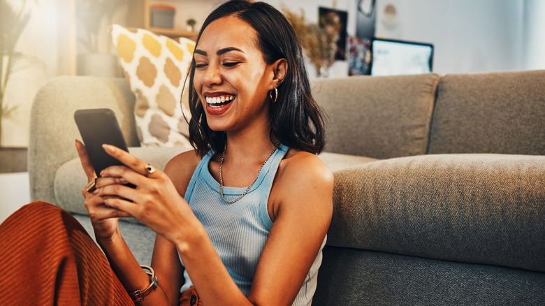 woman smiling at phone