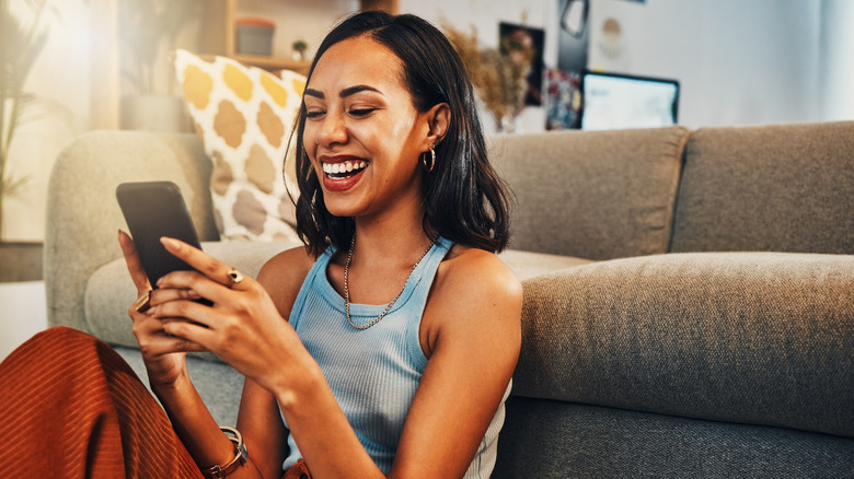 Woman smiling at her phone